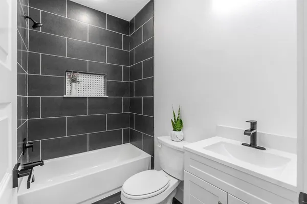 a bathroom with a toilet a sink and bathtub