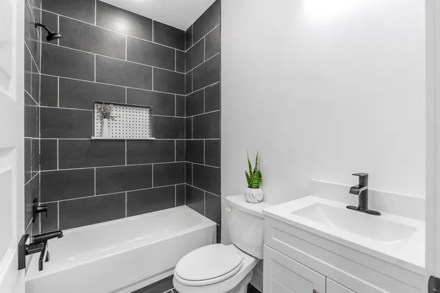 a bathroom with a toilet a sink and bathtub