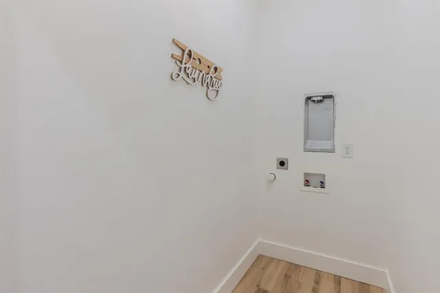 a workspace with wooden floor and windows