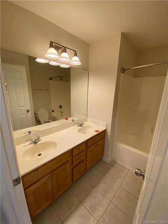 2736 Laurel Cherry Street Raleigh, NC 27612 - Photo 11 of 14 a bathroom with a tub sink and mirror