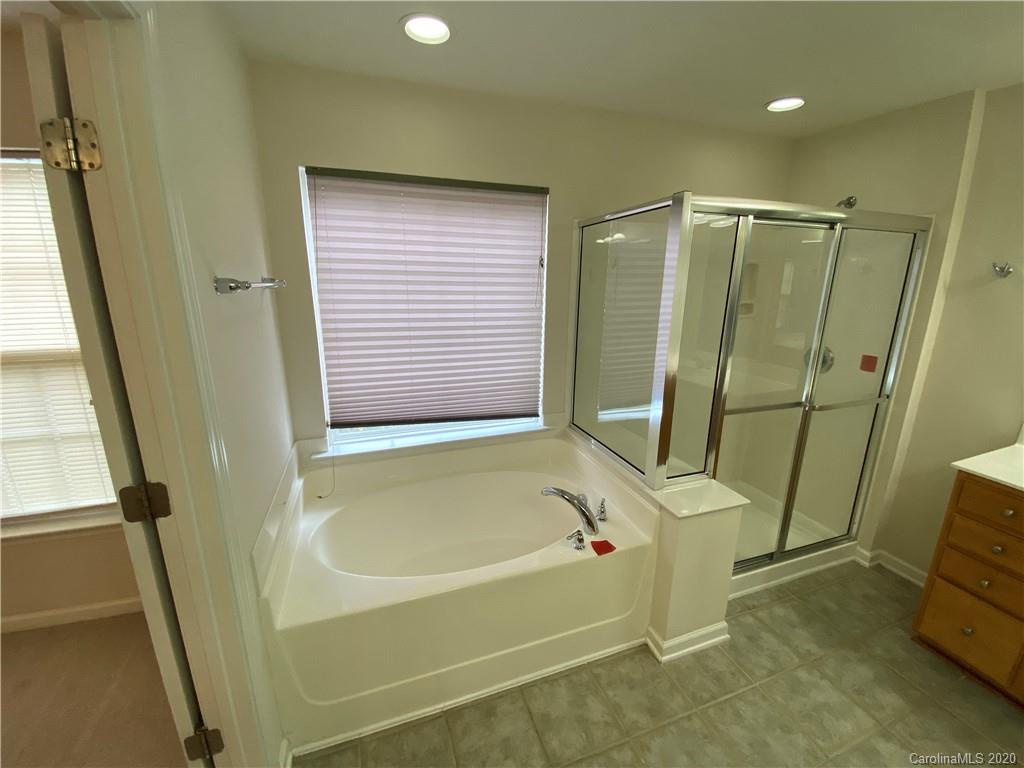 2736 Laurel Cherry Street Raleigh, NC 27612 - Photo 7 of 14 a bathroom with a bathtub and a shower