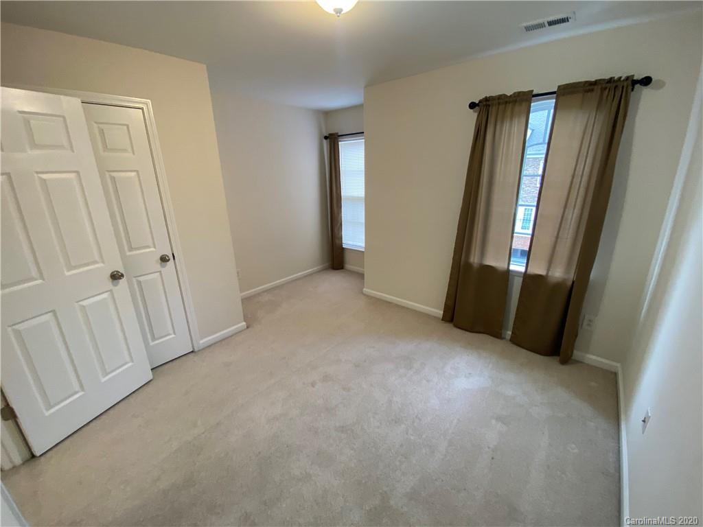 2736 Laurel Cherry Street Raleigh, NC 27612 - Photo 8 of 14 an empty room with windows and closet