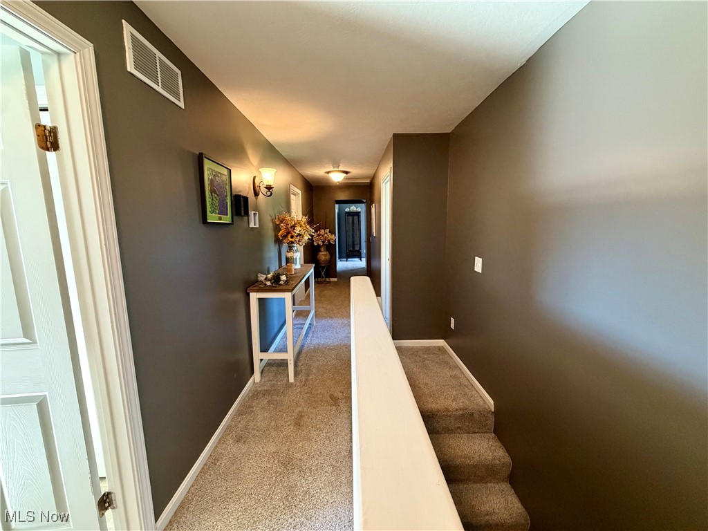 7374 Virginia Road Atwater, OH 44201 - Photo 20 of 49 Corridor featuring light carpet and stairs
