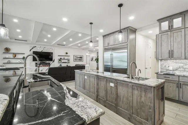 a large white bathroom with a tub sink and glass door shower