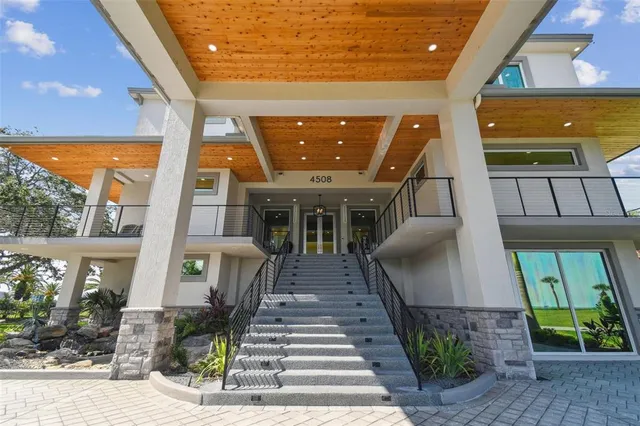 a spacious bedroom with a bed a couch and dresser