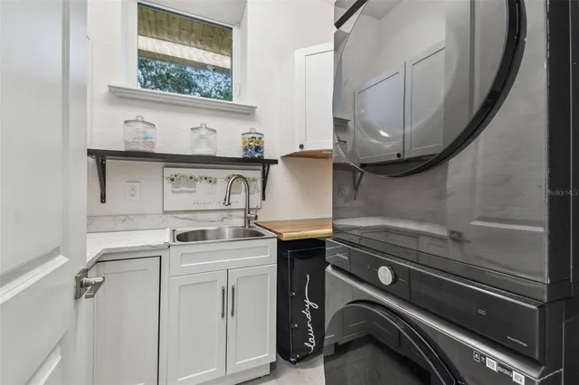 a kitchen with stainless steel appliances granite countertop a stove and a large window