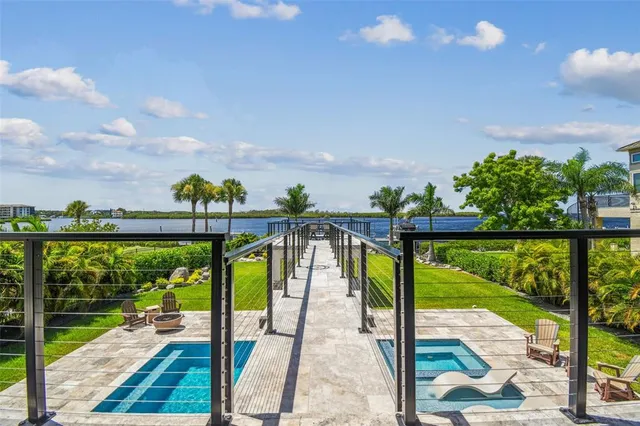 a view of a patio with table and chairs with wooden fence