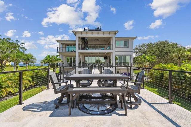 a view of a patio with table and chairs with wooden fence