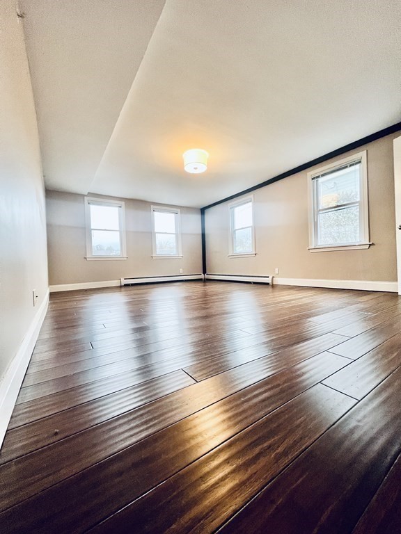 166 Pleasant Street, Unit 1 Marblehead, MA 01945 - Photo 6 of 10 a view of empty room with wooden floor