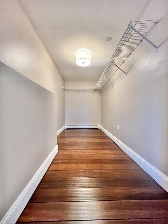 166 Pleasant Street, Unit 1 Marblehead, MA 01945 - Photo 7 of 10 a view of a room with wooden floor and white walls