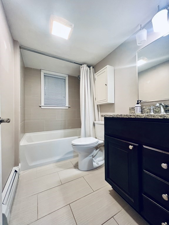 166 Pleasant Street, Unit 1 Marblehead, MA 01945 - Photo 10 of 10 a bathroom with a bathtub a sink a toilet a mirror and vanity