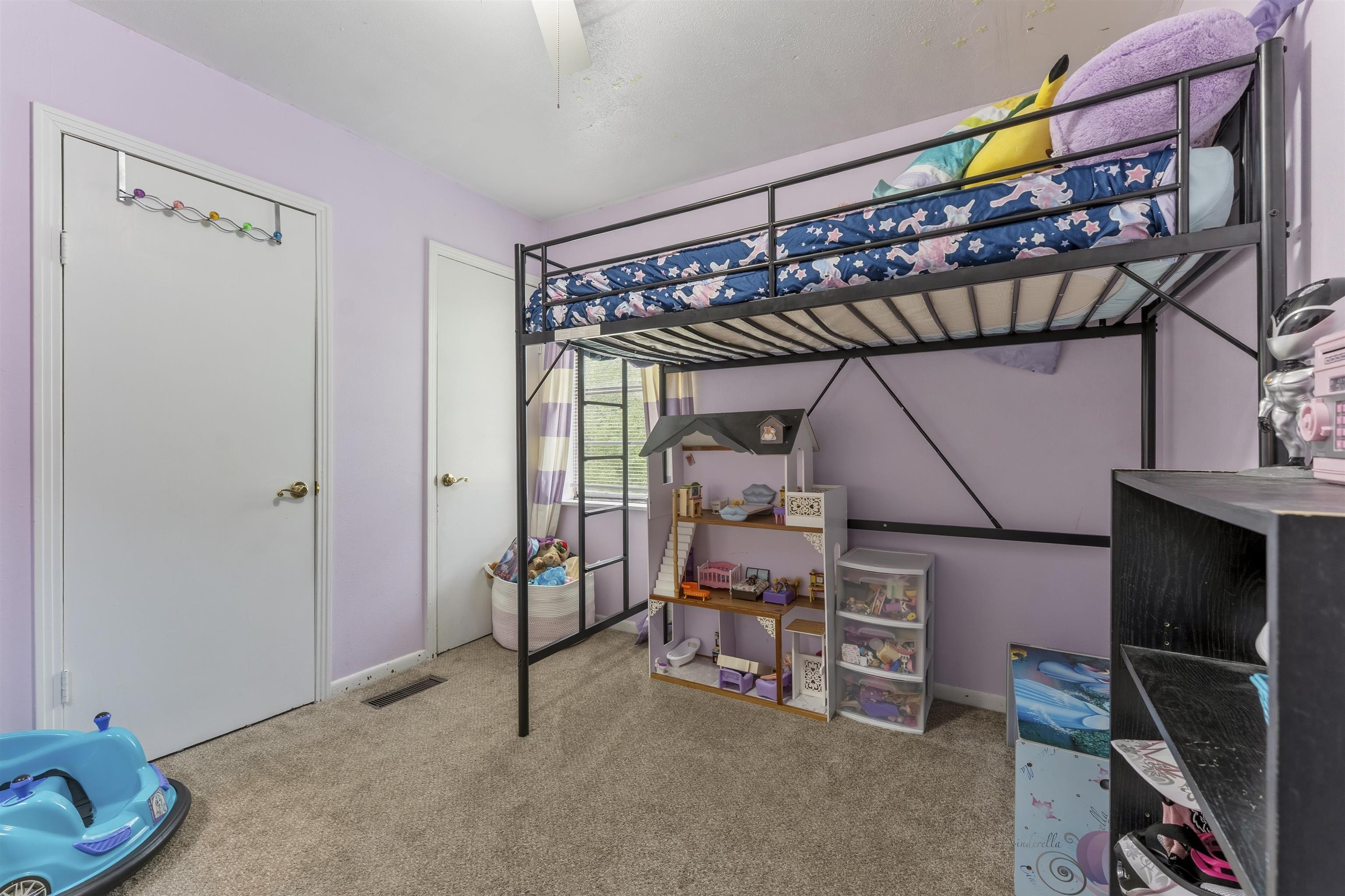 17 Walnut Road Munford, TN 38058 - Photo 19 of 20 Bedroom with light colored carpet, a closet, and ceiling fan