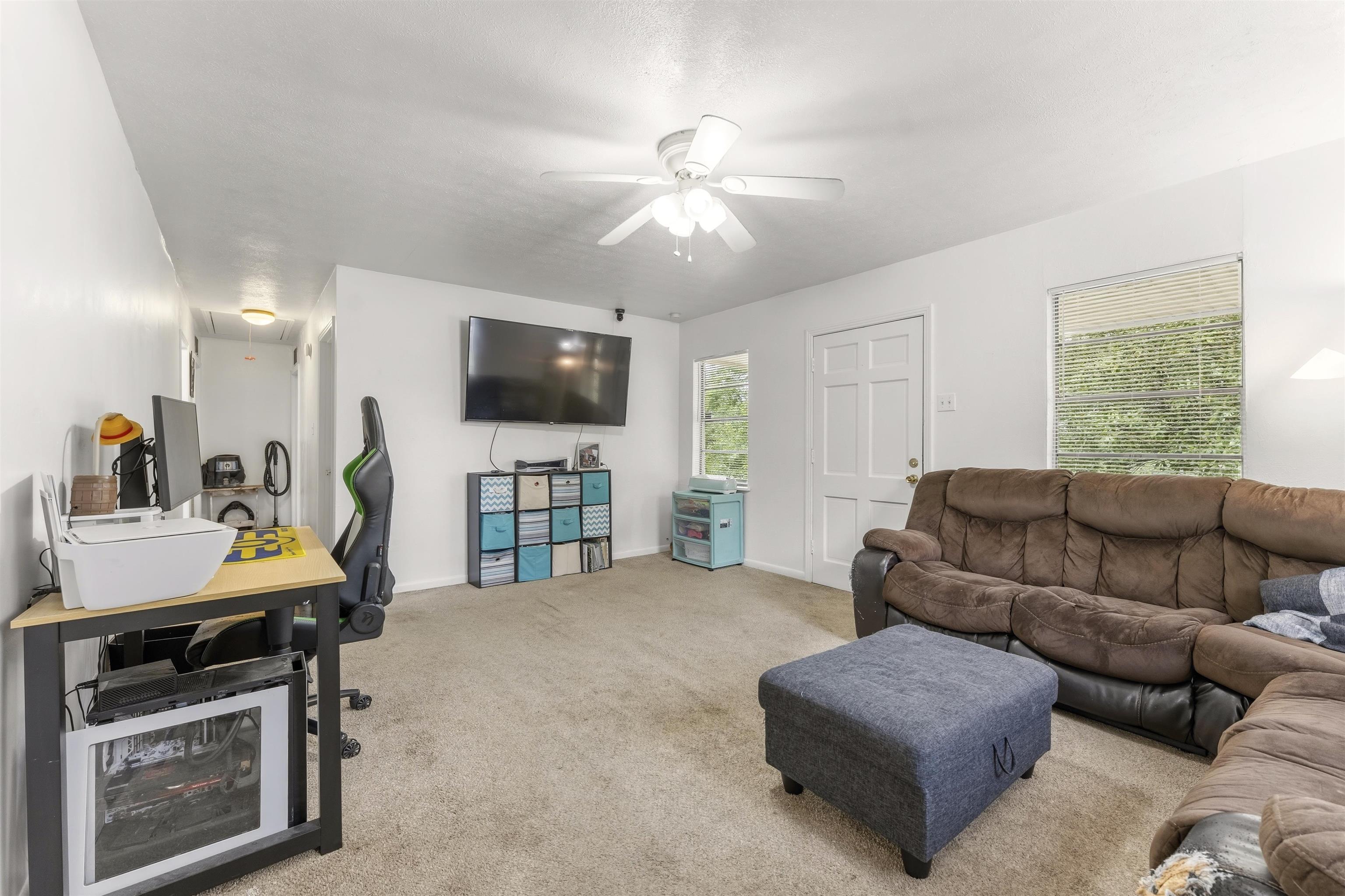 17 Walnut Road Munford, TN 38058 - Photo 7 of 20 Living room featuring light carpet and a ceiling fan