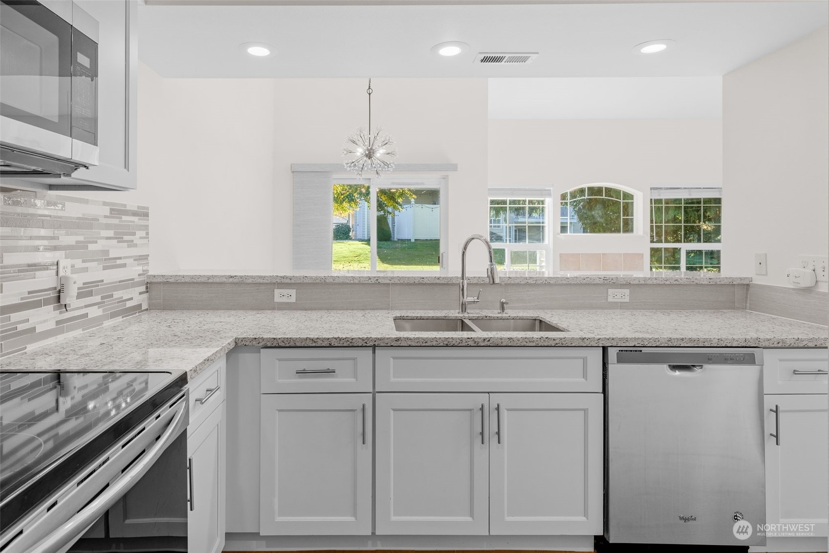 1921 South 368th Place Federal Way, WA 98003 - Photo 6 of 20 a kitchen with granite countertop white cabinets and a window