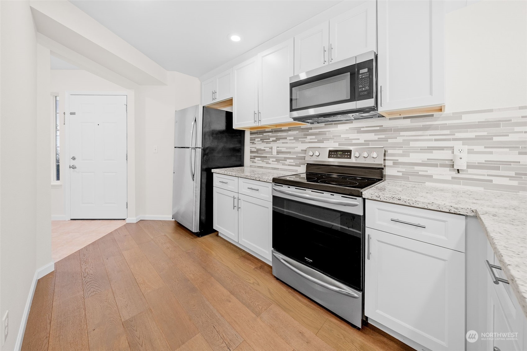 1921 South 368th Place Federal Way, WA 98003 - Photo 7 of 20 a kitchen with granite countertop white cabinets stainless steel appliances and a sink