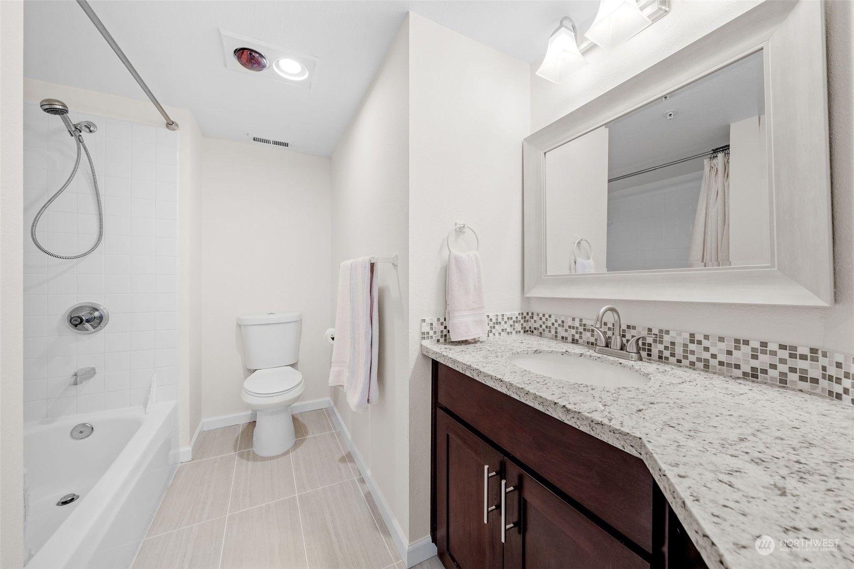 1921 South 368th Place Federal Way, WA 98003 - Photo 9 of 20 a bathroom with a granite countertop sink a toilet and a bathtub