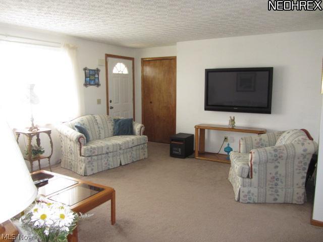 4685 Industry Road Ravenna, OH 44266 - Photo 2 of 21 The living room is open to the eating area.