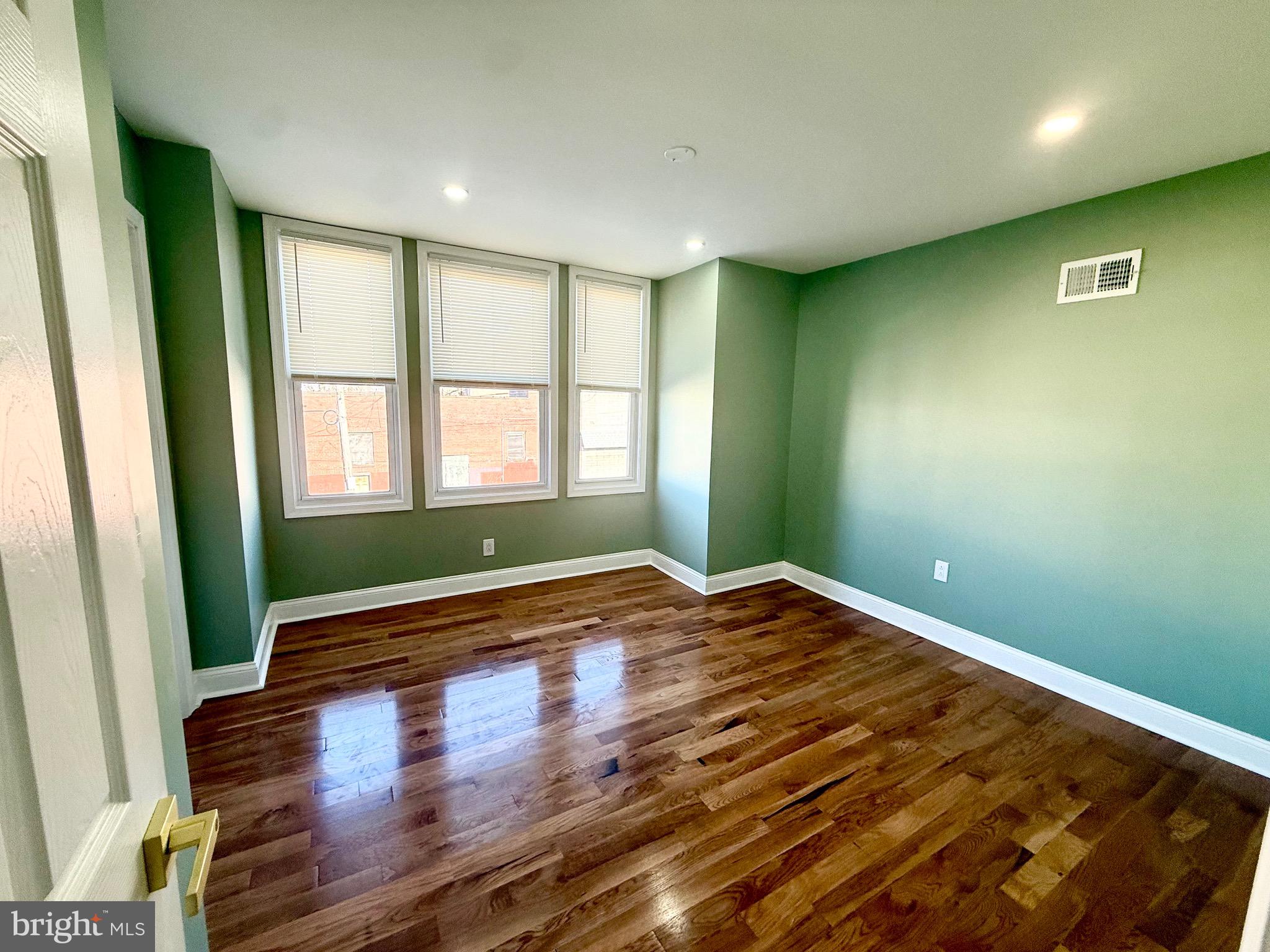 1942 South 56th Street Philadelphia, PA 19143 - Photo 22 of 36 a view of empty room with wooden floor and fan