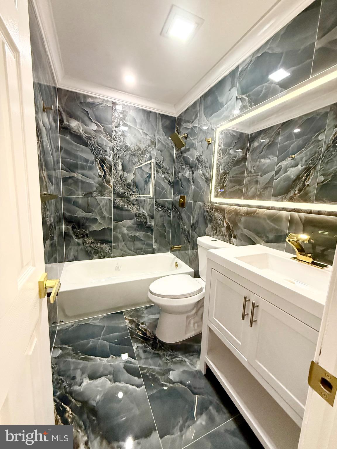 1942 South 56th Street Philadelphia, PA 19143 - Photo 26 of 36 a bathroom with a sink a toilet and shower