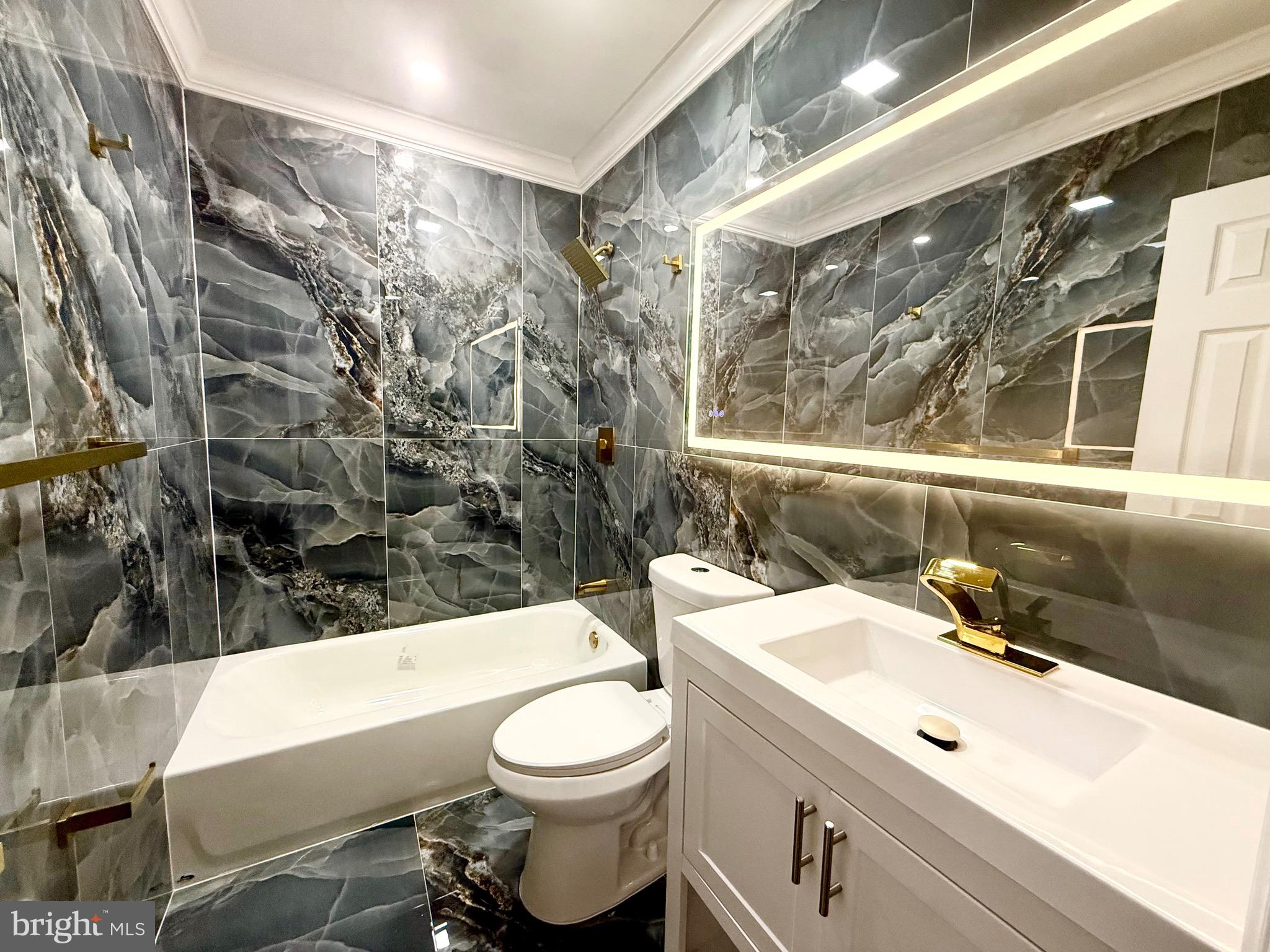 1942 South 56th Street Philadelphia, PA 19143 - Photo 27 of 36 a bathroom with a sink a toilet and bathtub