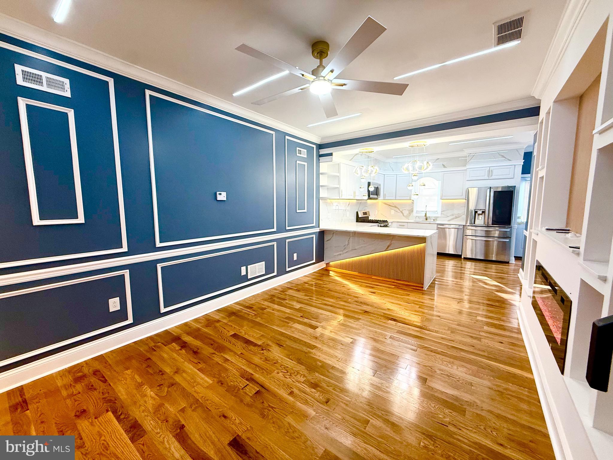 1942 South 56th Street Philadelphia, PA 19143 - Photo 4 of 36 a large kitchen with stainless steel appliances wooden floor and a large window