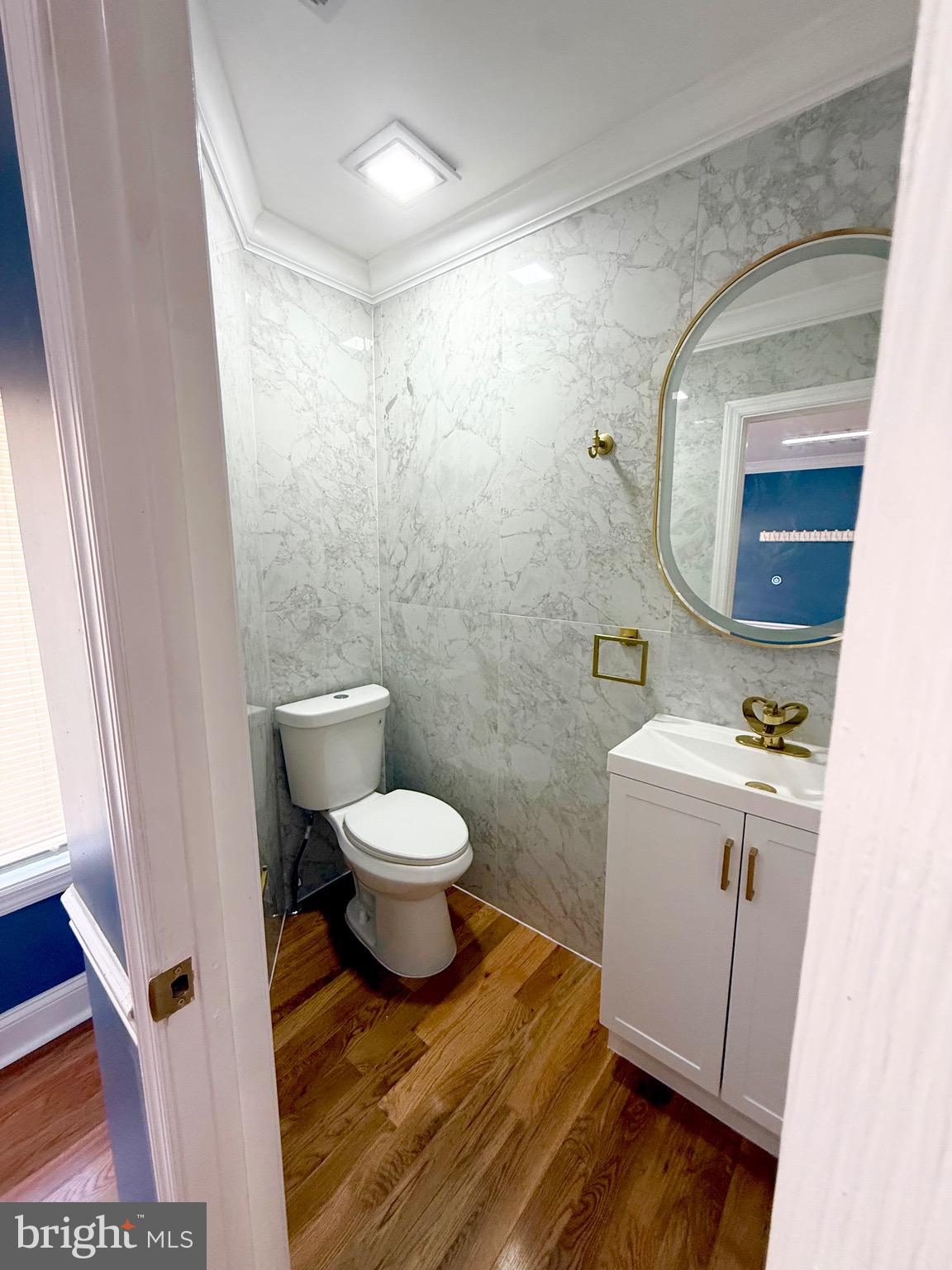 1942 South 56th Street Philadelphia, PA 19143 - Photo 6 of 36 a bathroom with a toilet sink and mirror