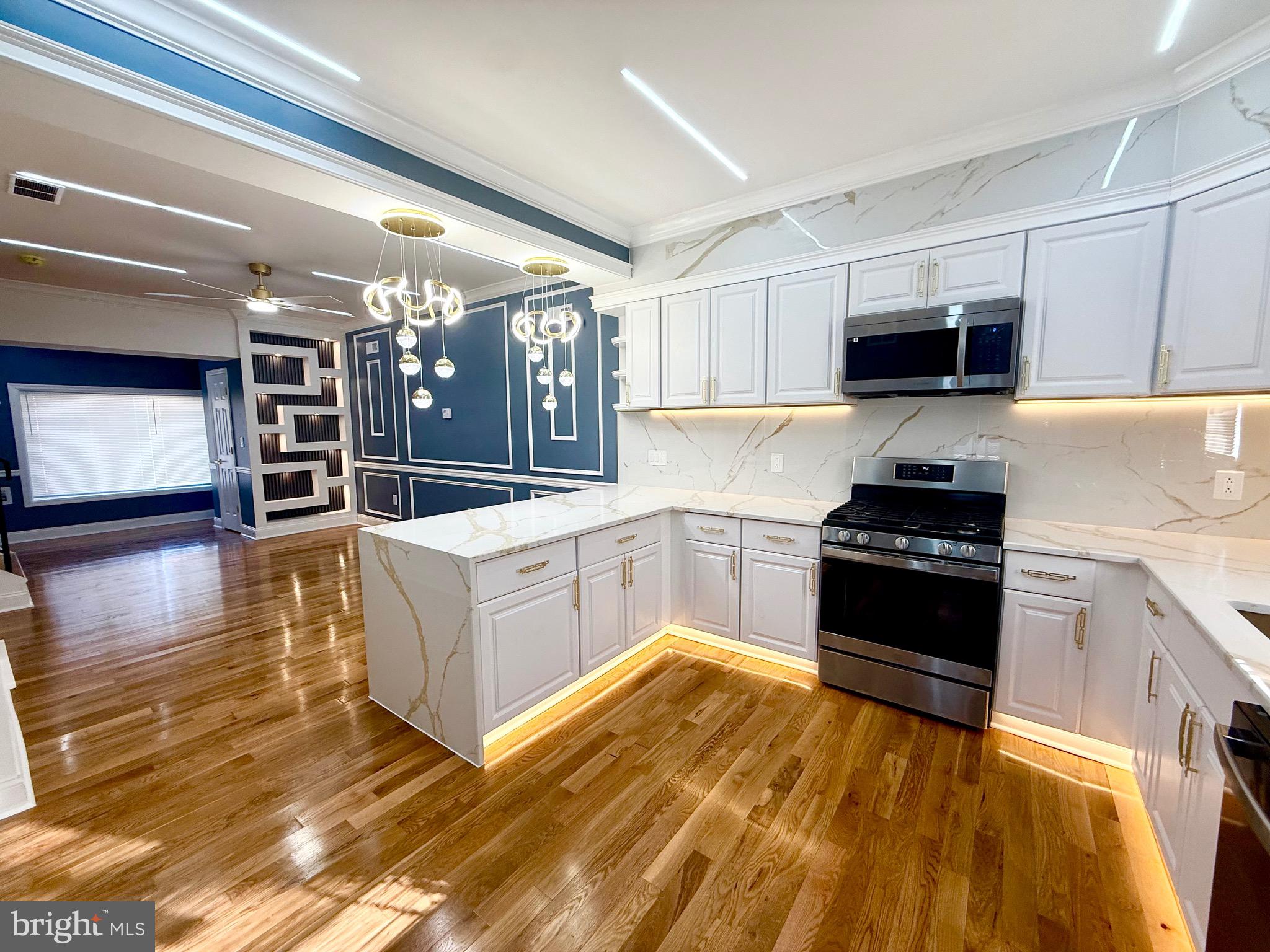 1942 South 56th Street Philadelphia, PA 19143 - Photo 10 of 36 a kitchen with stainless steel appliances granite countertop a stove and a sink