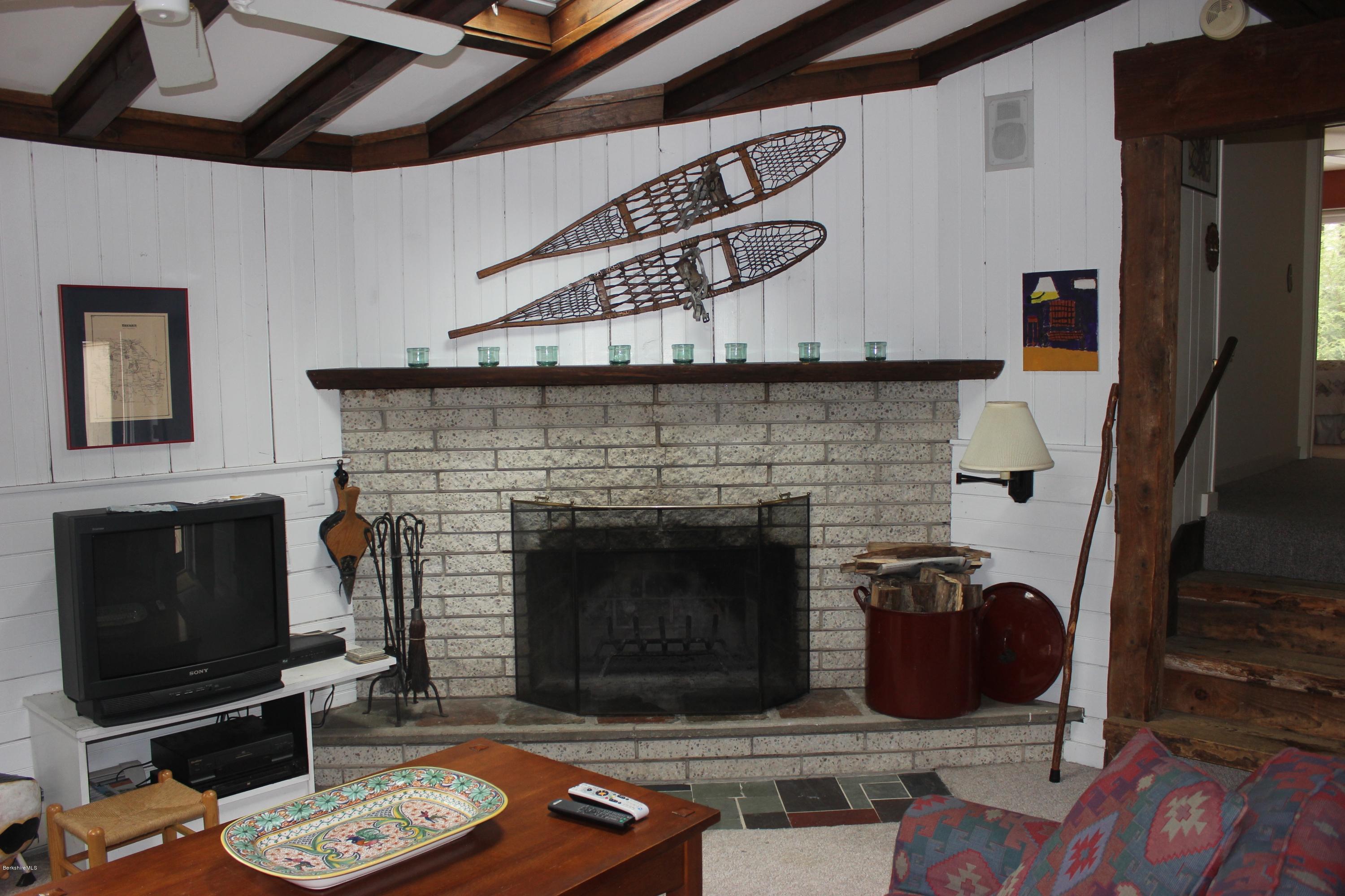 40 Williams Road Becket, MA 01223 - Photo 8 of 18 a living room with furniture a flat screen tv and a fireplace