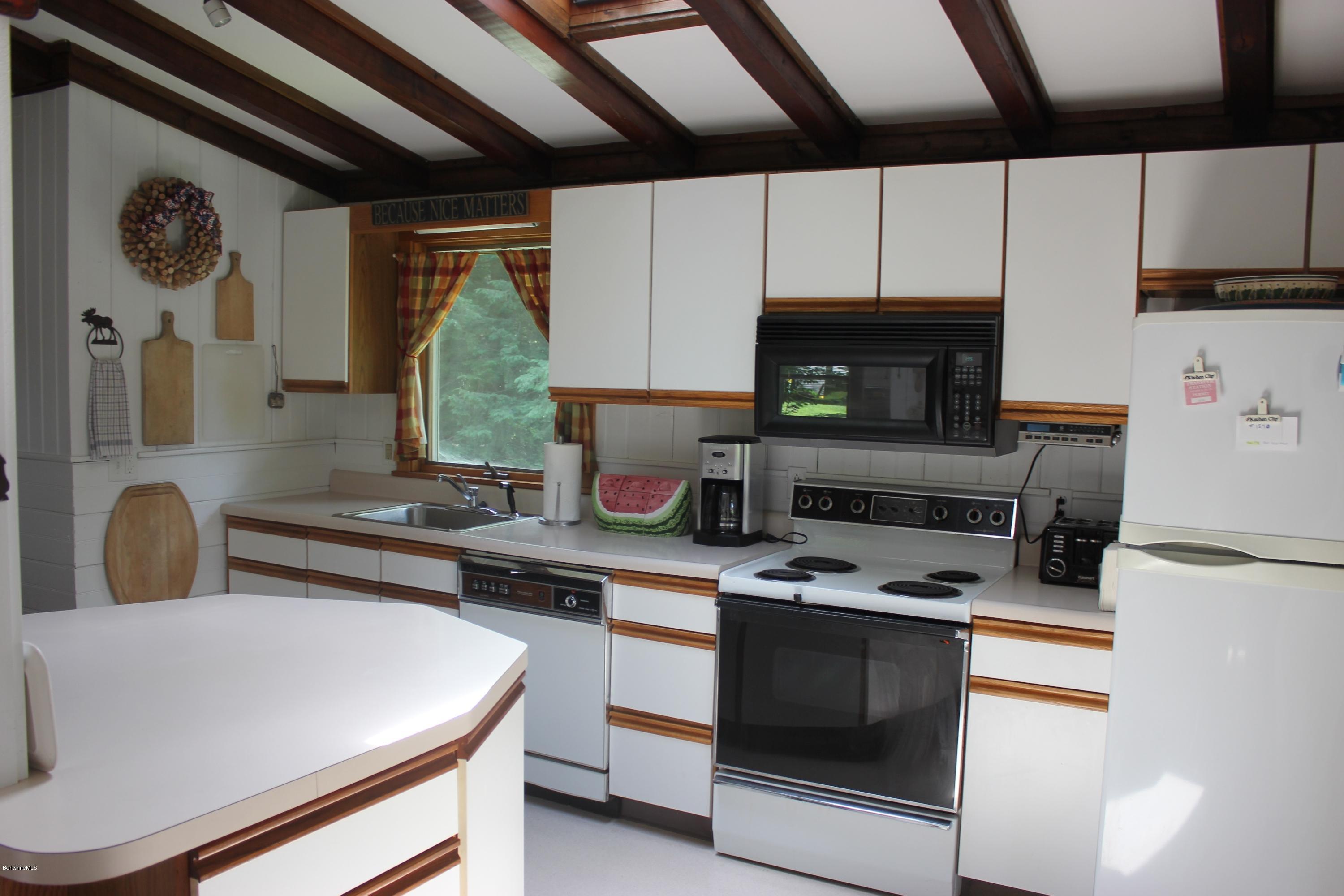 40 Williams Road Becket, MA 01223 - Photo 9 of 18 a kitchen with stainless steel appliances a stove a sink and a microwave