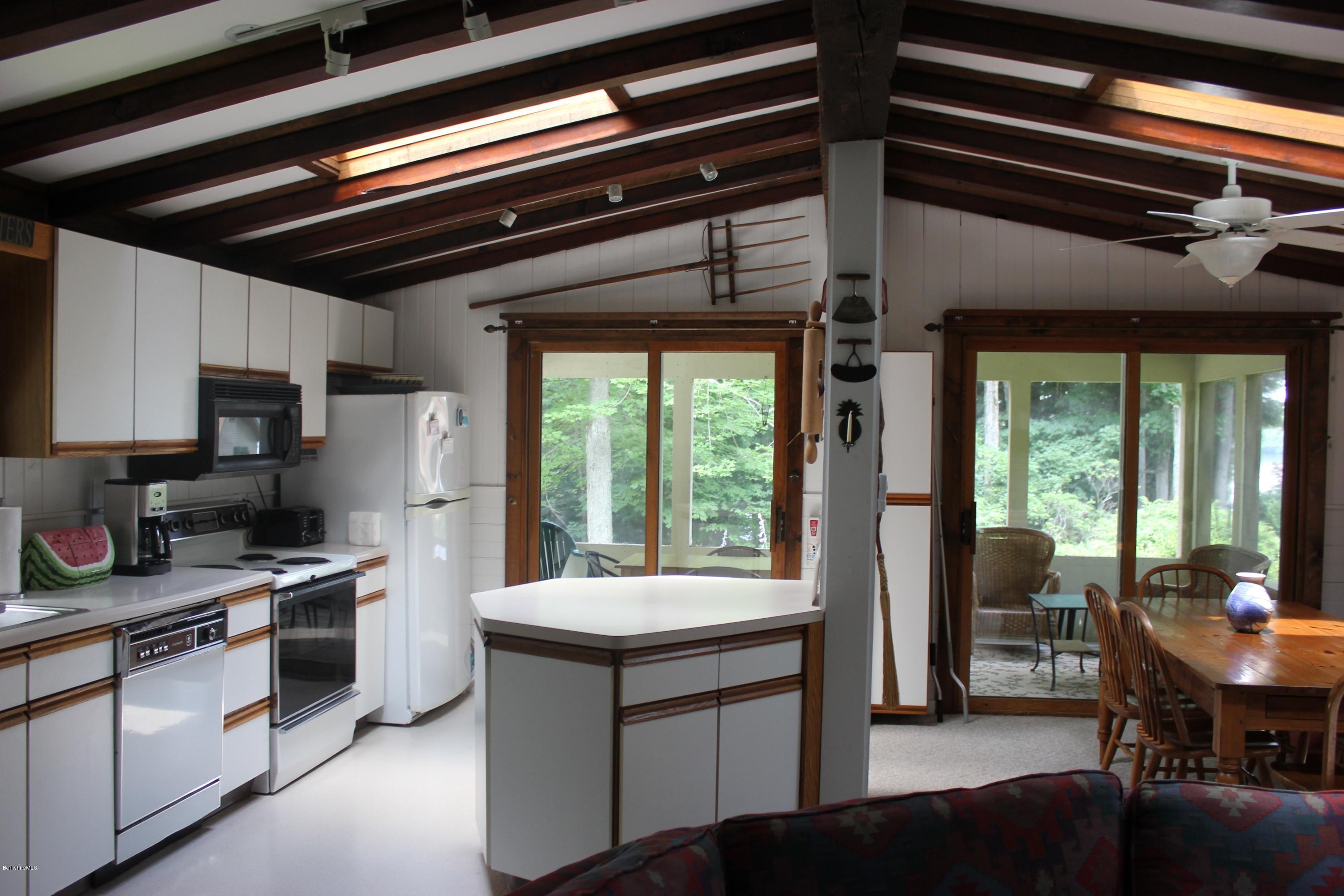 40 Williams Road Becket, MA 01223 - Photo 10 of 18 a kitchen with a stove a refrigerator and a dining table