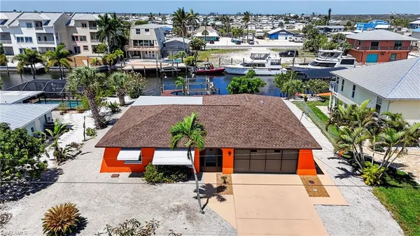 an aerial view of a house with yard porch and seating space
