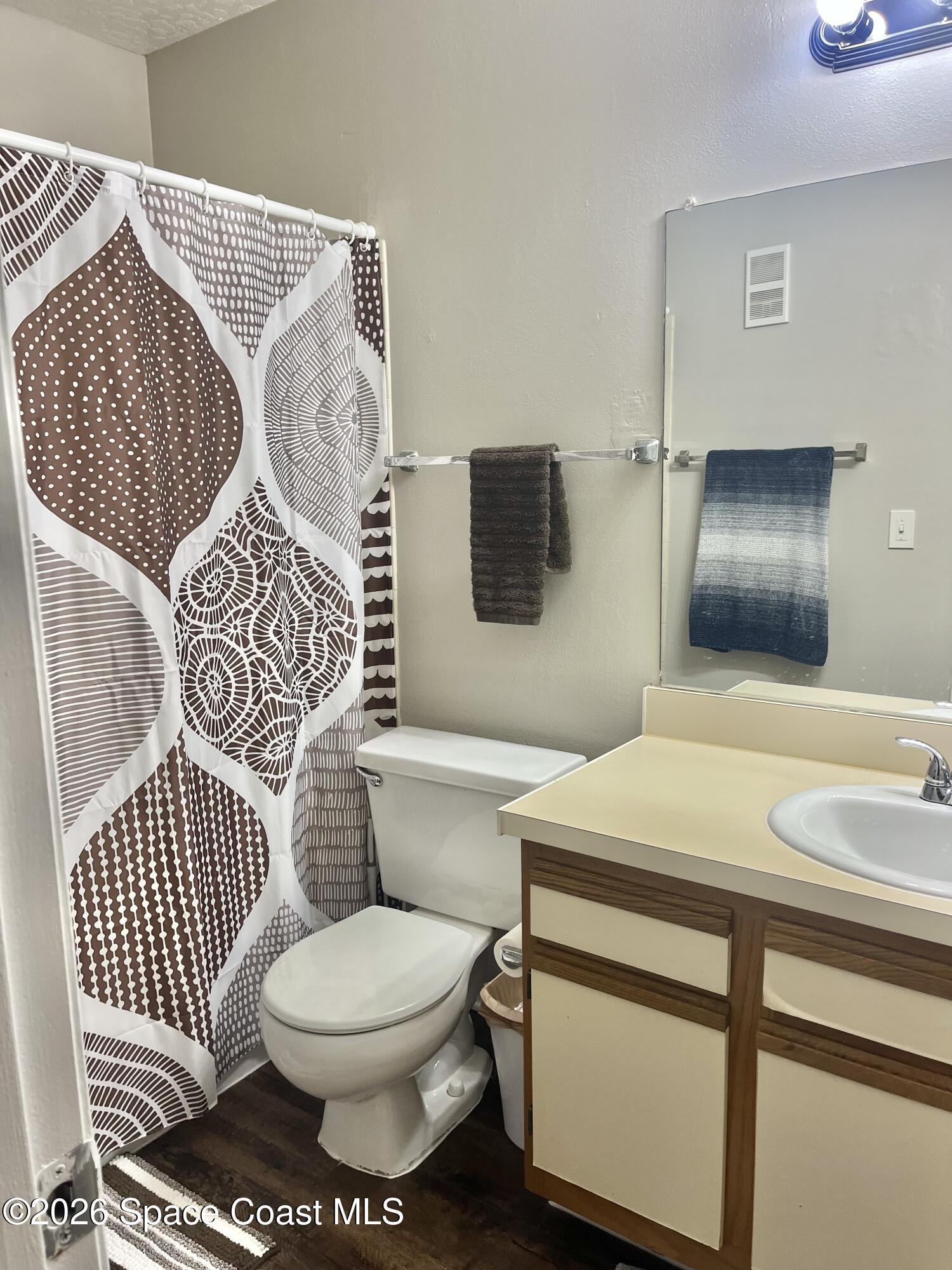 7667 North Wickham Road, Unit 1118 Melbourne, FL 32940 - Photo 11 of 26 a bathroom with a sink and a mirror