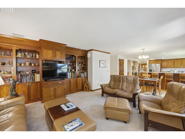 a living room with furniture a flat screen tv and a large window