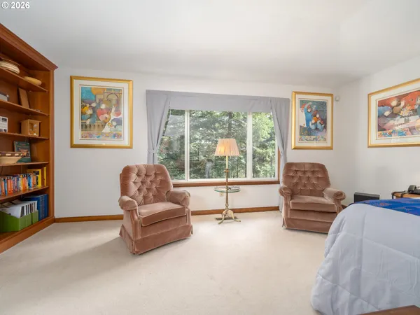 a spacious bedroom with a bed and a large window
