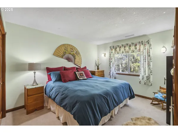 a bedroom with a bed a couch and dresser