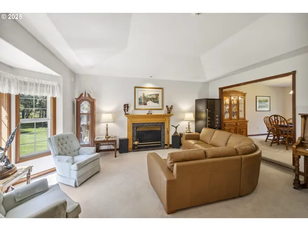 a living room with furniture large window and a fireplace