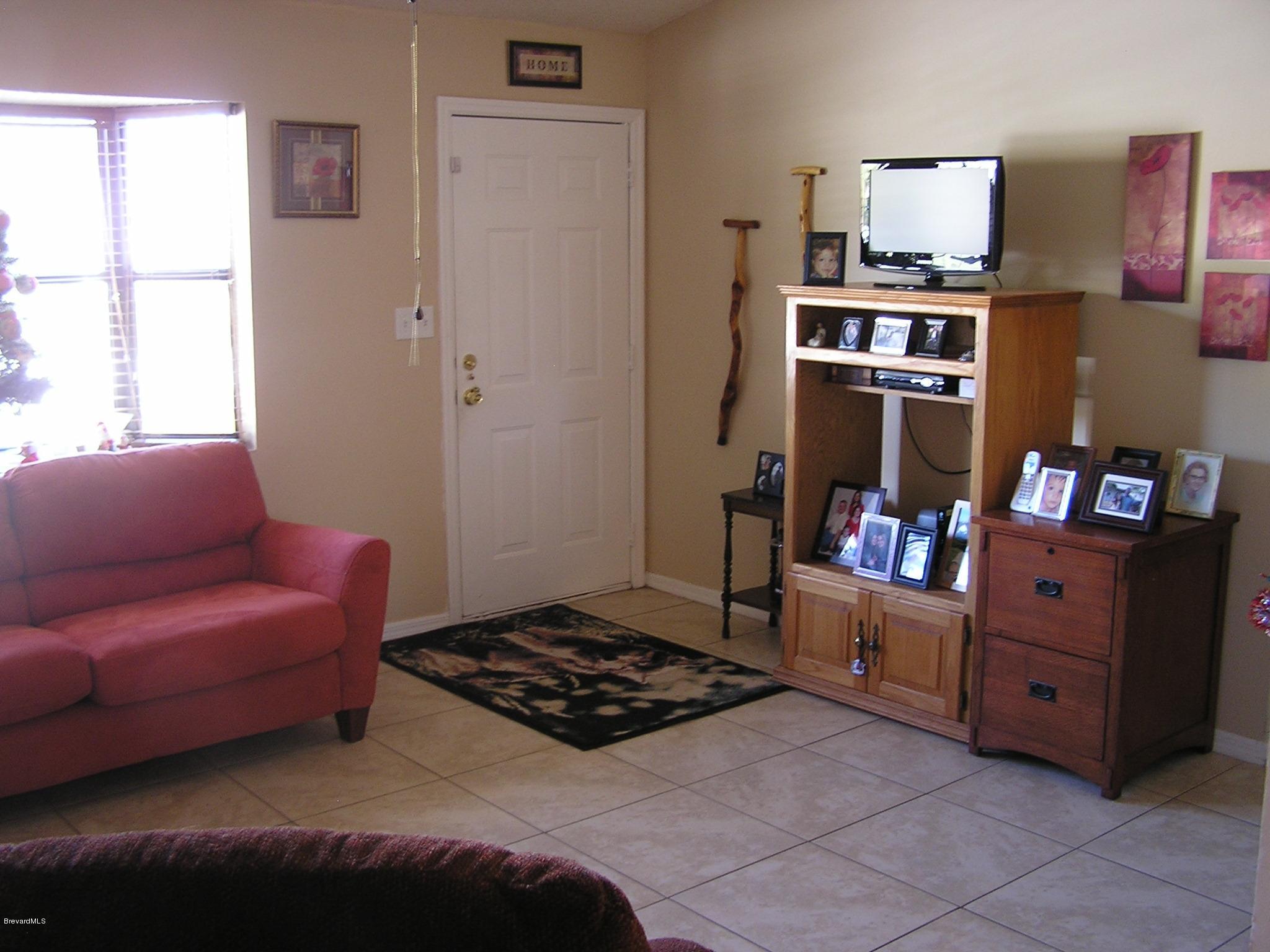 6474 Hudson Road Cocoa, FL 32927 - Photo 4 of 9 a living room with furniture and a window
