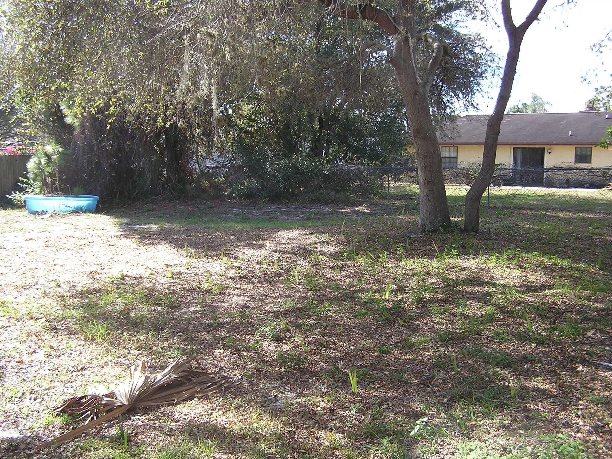 6474 Hudson Road Cocoa, FL 32927 - Photo 9 of 9 a backyard of a house with lots of green space