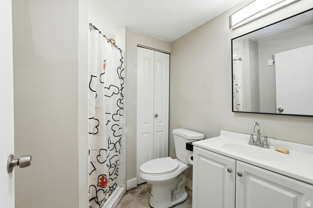 778 East 200 North Logan, UT 84321 - Photo 12 of 43 Bathroom featuring a white vanity with integrated sink, chrome faucet, and rectangular framed mirror