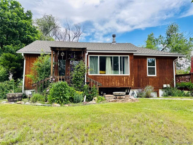 a view of a house with pool and garden