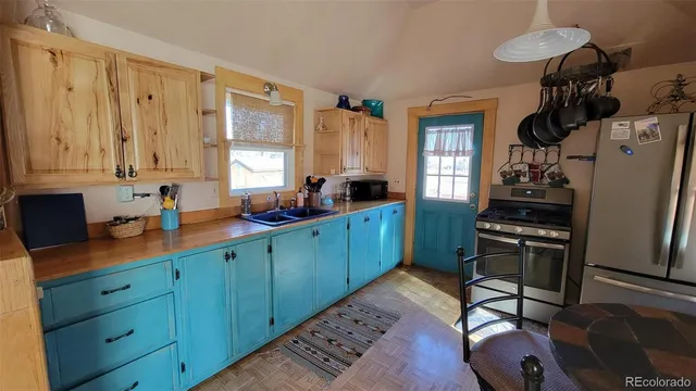a kitchen with stainless steel appliances granite countertop a sink stove and cabinets