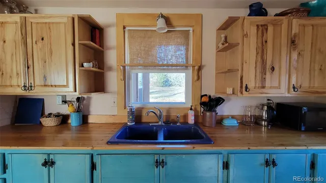 a kitchen with stainless steel appliances a sink a stove and a window