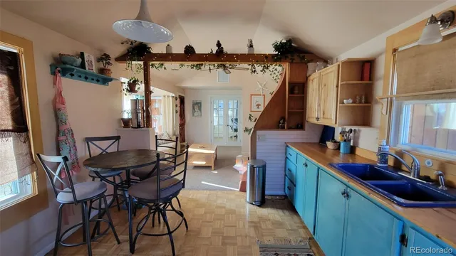 a view of a kitchen area with furniture and wooden floor