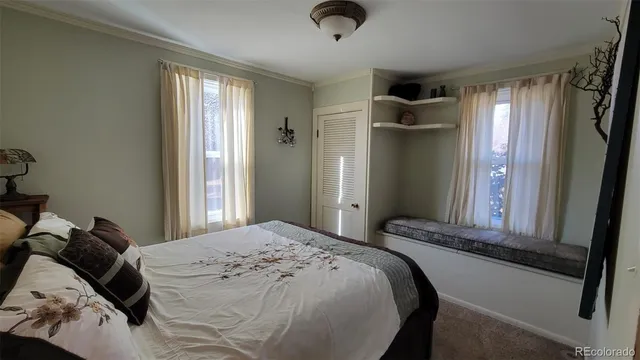 a bedroom with a bed and a large mirror