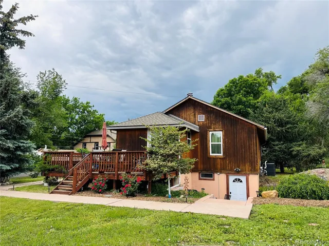 a front view of a house with porch and garden