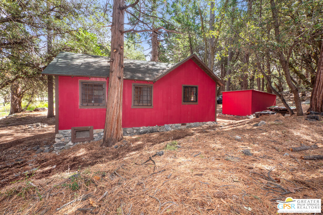 76 7 Oaks Road Angelus Oaks, CA 92305 - Photo 26 of 35 a view of a red house with a yard and large tree