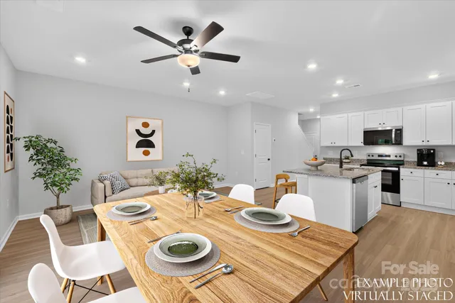 a kitchen with a dining table and chairs