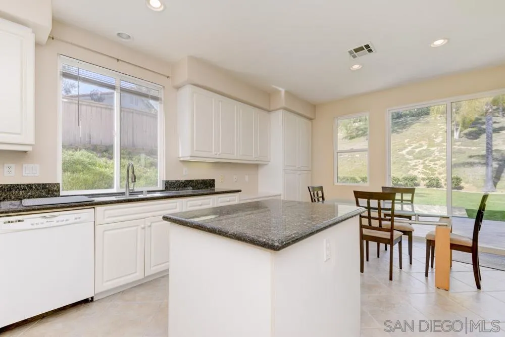 3224 Rancho Arroba Carlsbad, CA 92009 - Photo 17 of 35 a kitchen with stainless steel appliances granite countertop a stove a sink and a granite counter tops with white cabinets