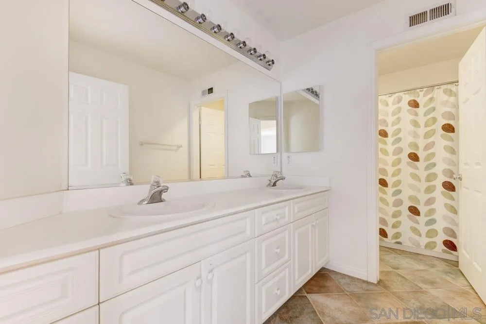 3224 Rancho Arroba Carlsbad, CA 92009 - Photo 26 of 35 a bathroom with a double vanity sink and a mirror