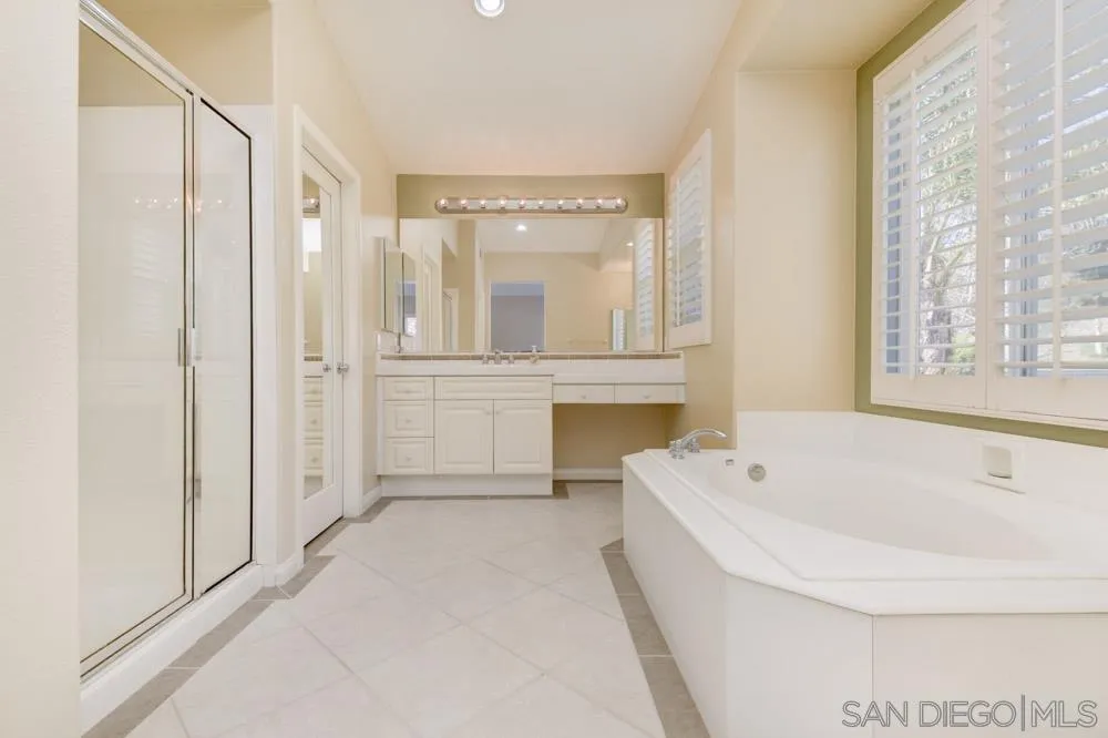 3224 Rancho Arroba Carlsbad, CA 92009 - Photo 33 of 35 a spacious bathroom with a tub shower and sink